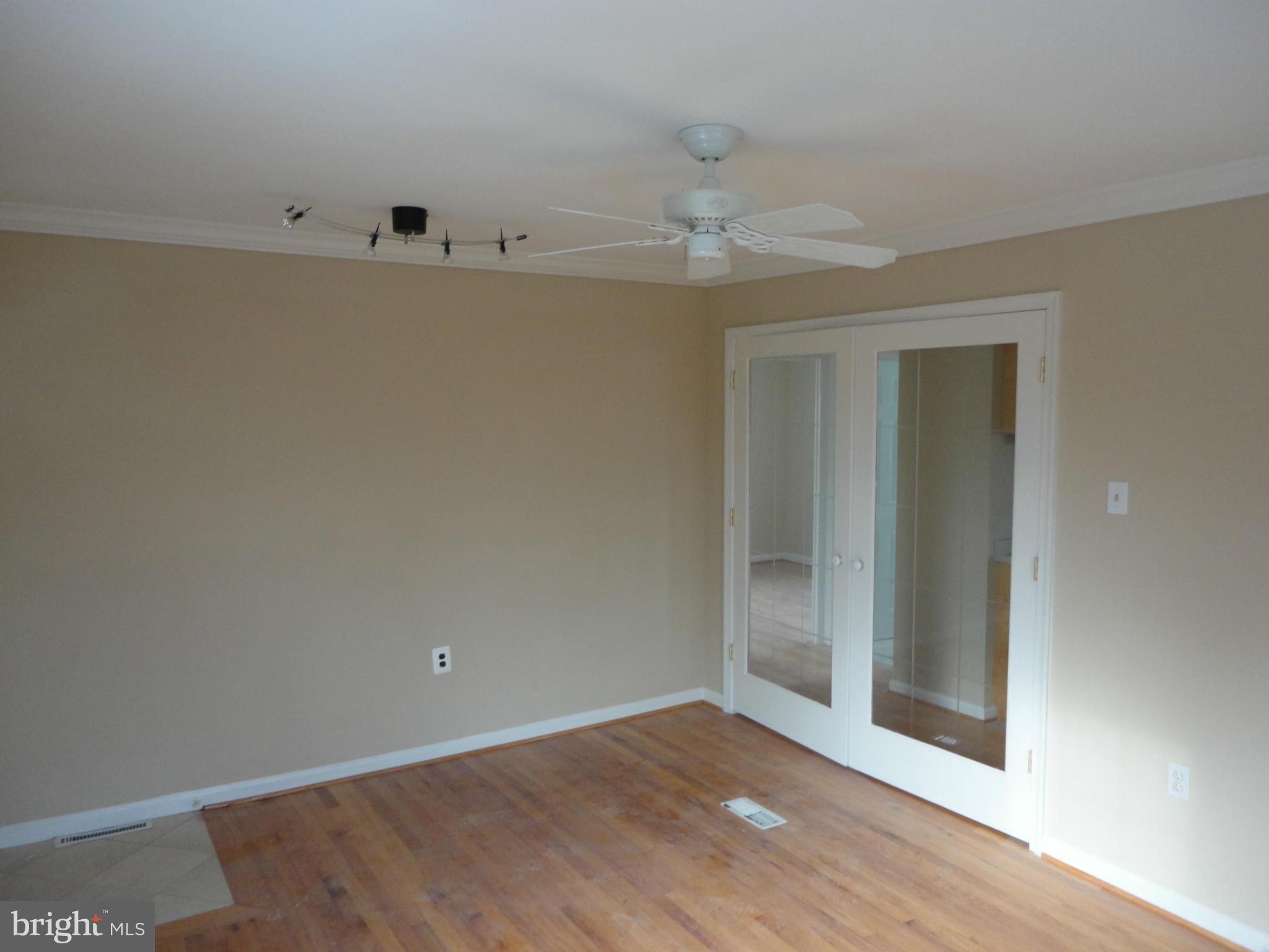 11509 Joseph Mill Road Silver Spring, MD 20906 - Photo 14 of 24 an empty room with wooden floor and windows