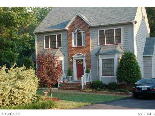 11901 Taplow Road Midlothian, VA 23112 - Photo 1 of 7 a front view of a house with a yard and trees