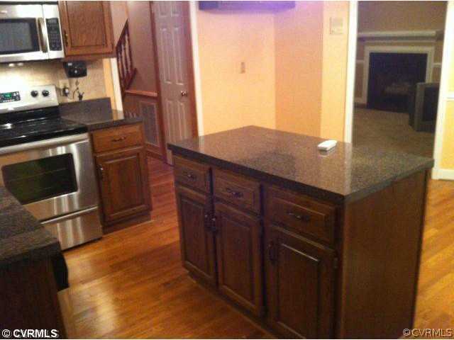 11901 Taplow Road Midlothian, VA 23112 - Photo 4 of 7 a kitchen with stainless steel appliances granite countertop a stove a sink and a microwave
