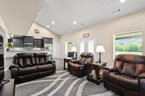 a living room with furniture kitchen and a window