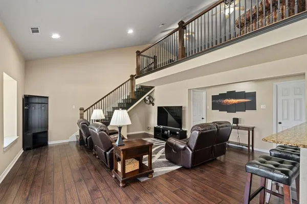 a living room with furniture and a wooden floor