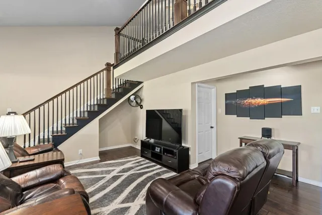 a bedroom with two beds and a painting on the wall