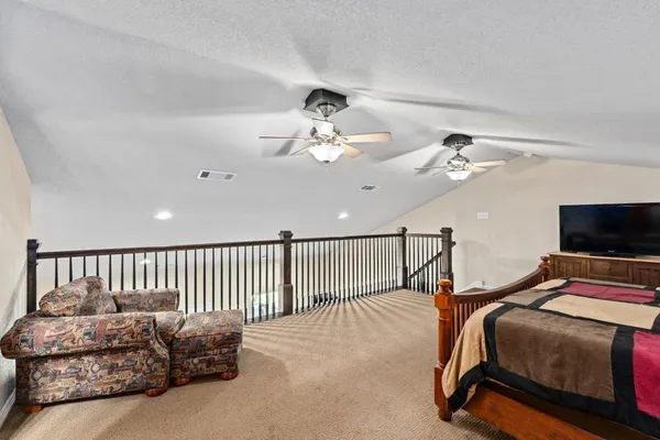a bedroom with bed and a tv