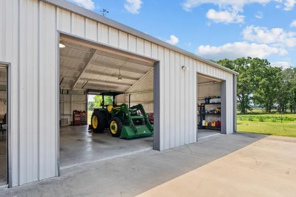 a view of a big room with a large window and sitting space