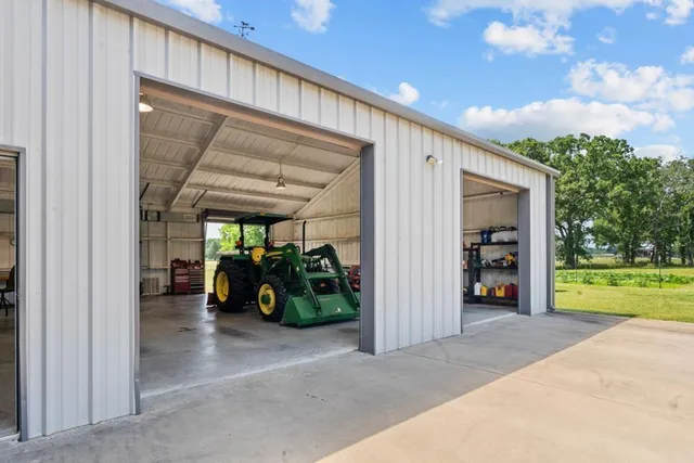 a view of a big room with a large window and sitting space
