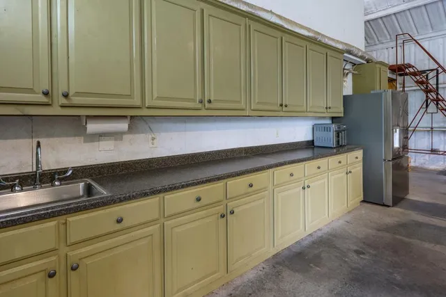 a kitchen with granite countertop cabinets and white appliances