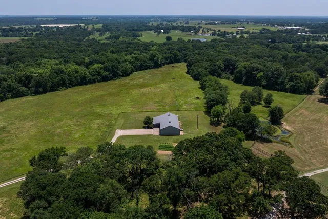 an aerial view of a house with a yard