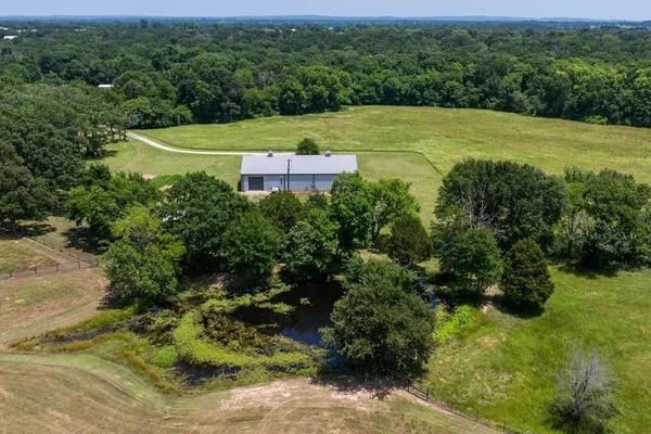 a view of a big yard with large trees