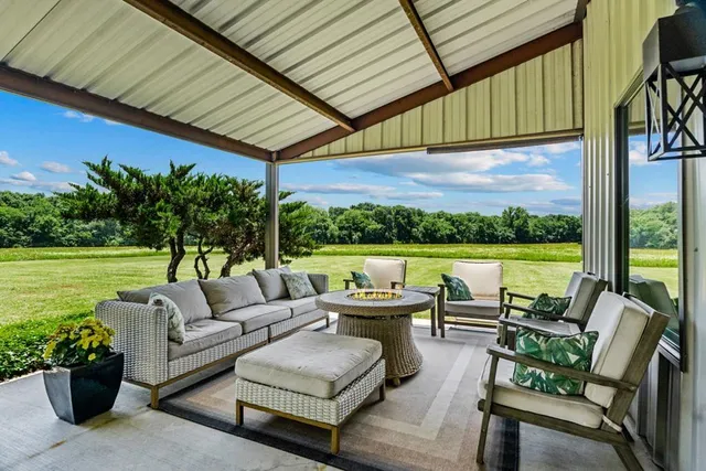 a balcony with furniture and garden view