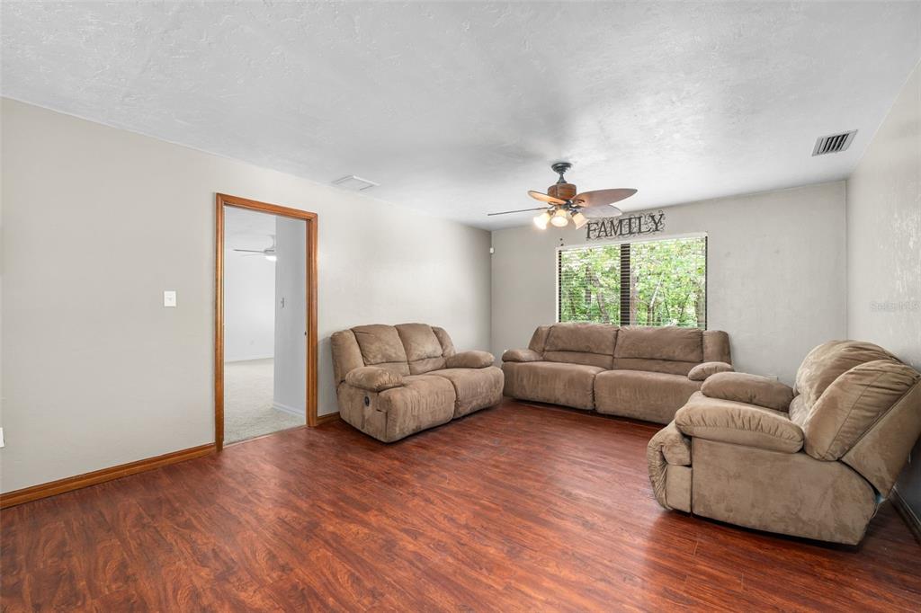 4703 Northwest 124th Street Gainesville, FL 32606 - Photo 34 of 55 a living room with furniture and a large window
