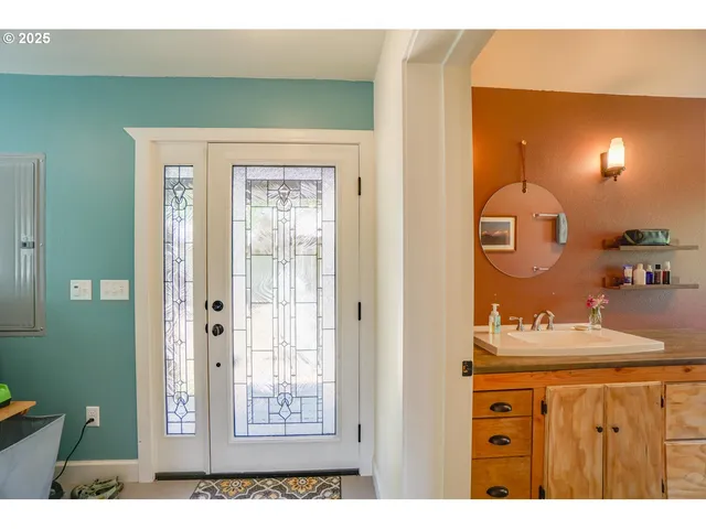a bathroom with a sink mirror and vanity
