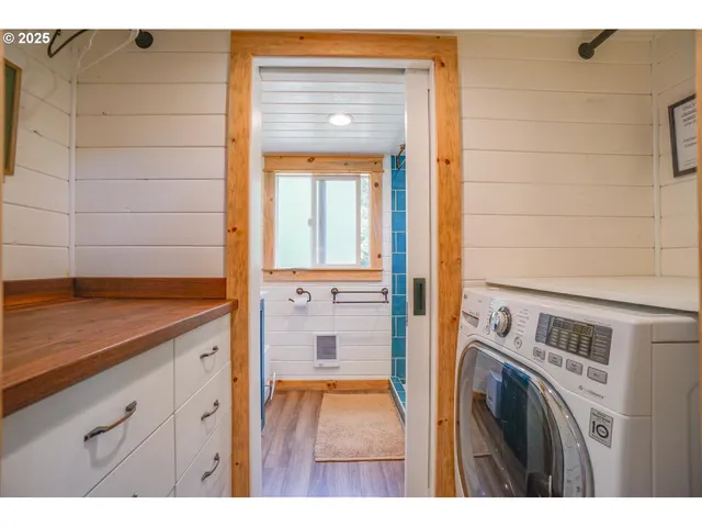a view of a bathroom with a sink and a washer dryer