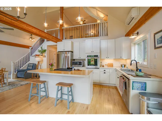 a kitchen with kitchen island granite countertop lots of counter top space and appliances