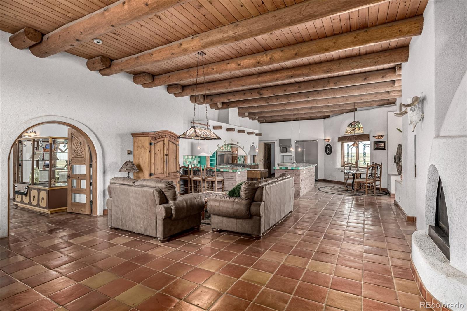 4601 County Road 161 Strasburg, CO 80136 - Photo 12 of 50 a living room with fireplace furniture and a flat screen tv