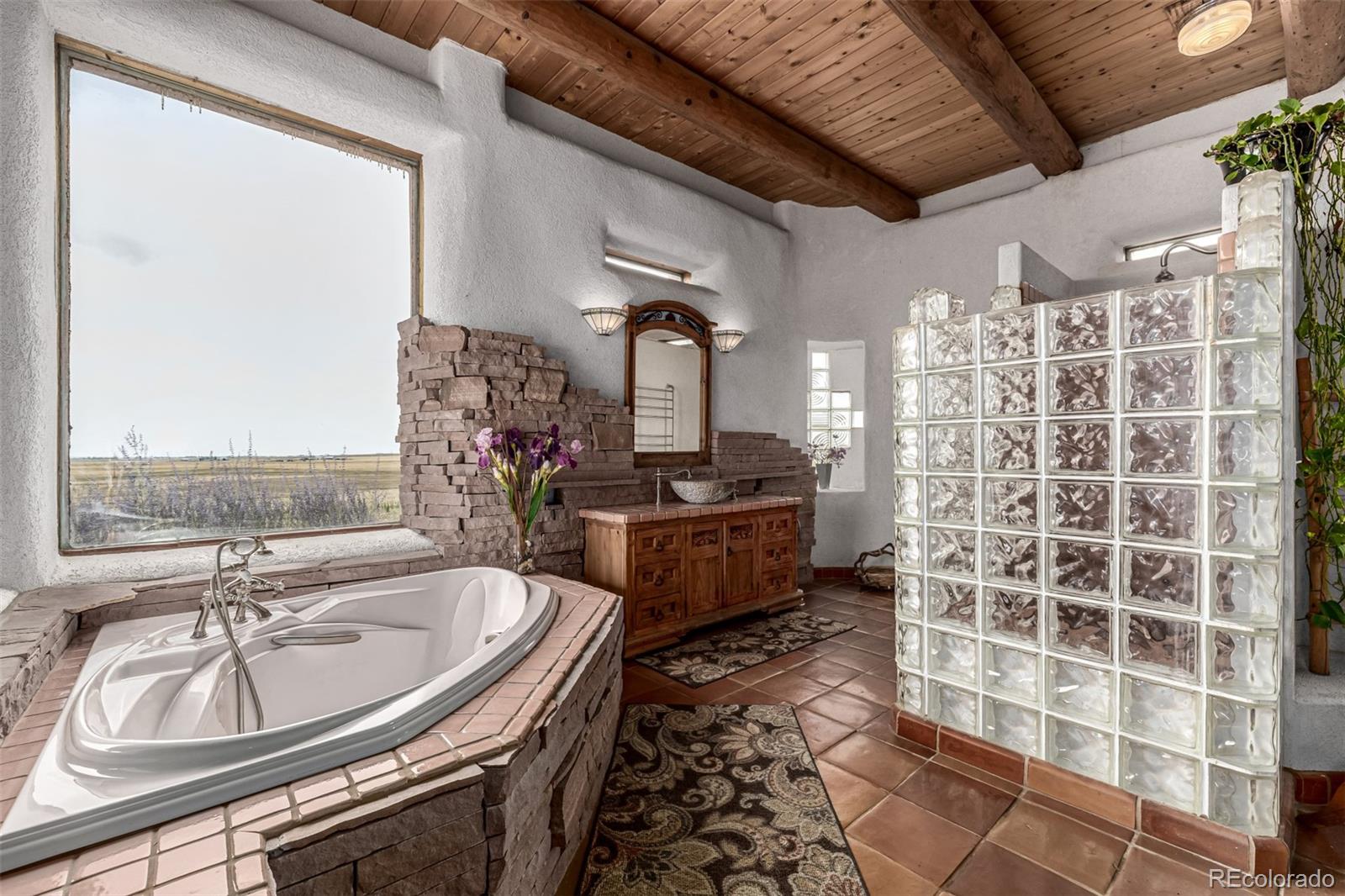 4601 County Road 161 Strasburg, CO 80136 - Photo 25 of 50 a bathroom with a sink a mirror and a shower