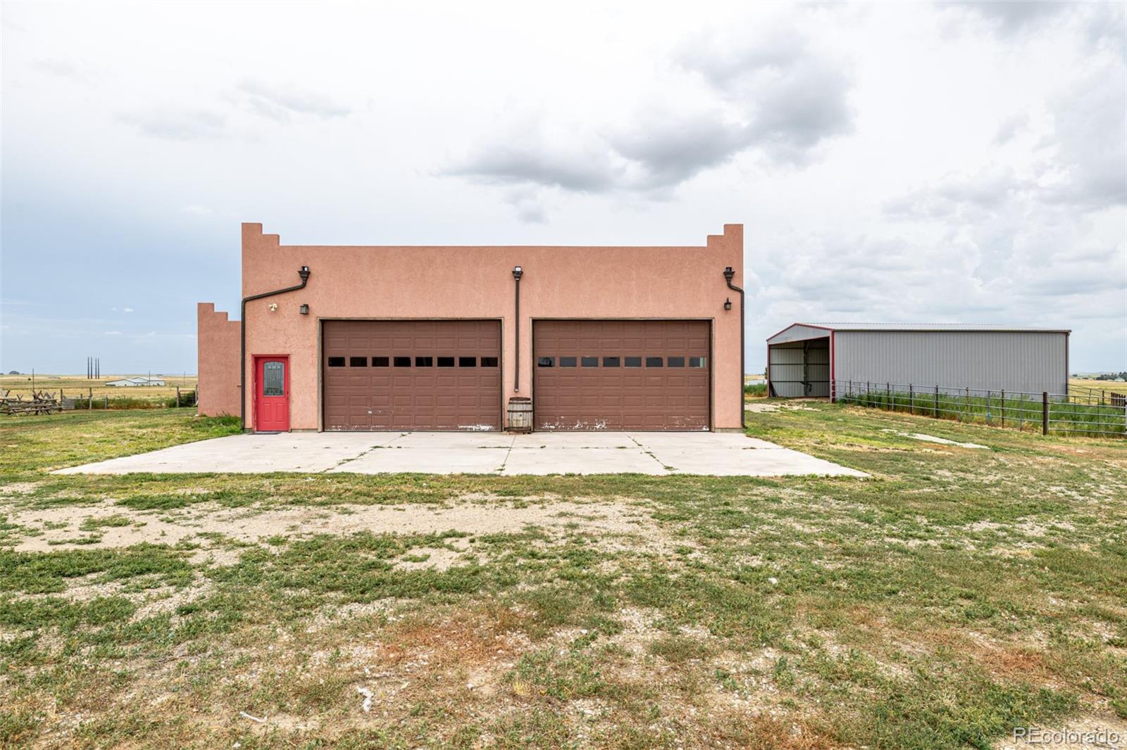 4601 County Road 161 Strasburg, CO 80136 - Photo 41 of 50 a view of a house with a yard and garage