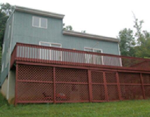 1344 Hickory Falls Road Blue Ridge, VA 24064 - Photo 2 of 5 a view of backyard with wooden fence and a stairs
