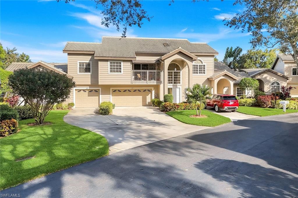 269 Perignon Place, Unit 162 Naples, FL 34119 - Photo 1 of 36 a front view of a house with a big yard and potted plants