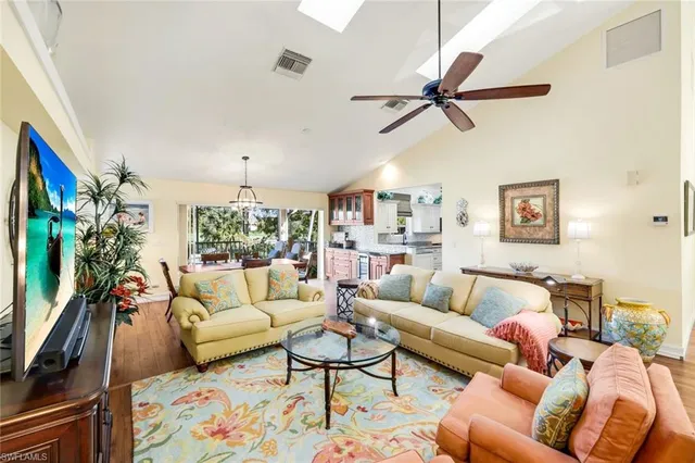a living room with furniture ceiling fan and a rug
