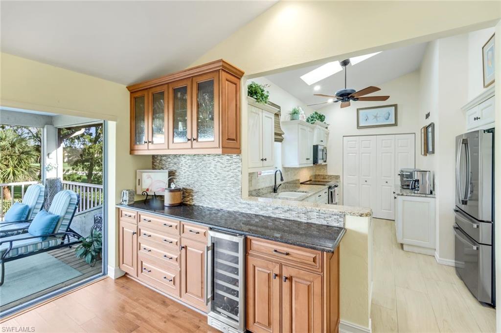 269 Perignon Place, Unit 162 Naples, FL 34119 - Photo 16 of 36 a kitchen with stainless steel appliances granite countertop a refrigerator and a stove top oven