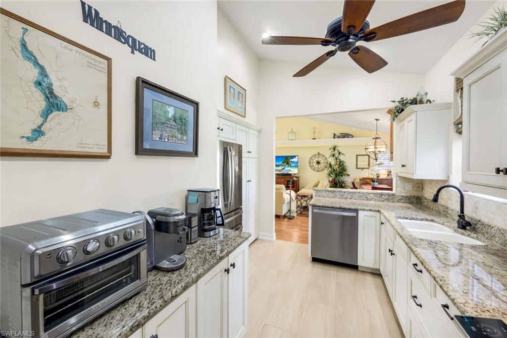 269 Perignon Place, Unit 162 Naples, FL 34119 - Photo 18 of 36 a kitchen with a stove and a sink