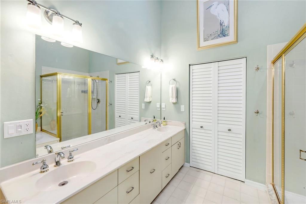 269 Perignon Place, Unit 162 Naples, FL 34119 - Photo 22 of 36 a bathroom with a double vanity sink mirror and double