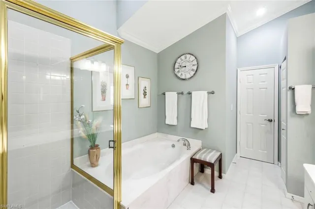 a bathroom with a tub shower and mirror