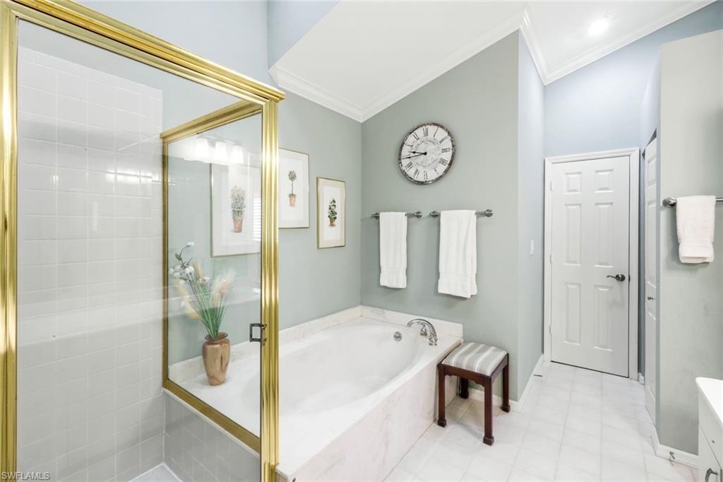 269 Perignon Place, Unit 162 Naples, FL 34119 - Photo 23 of 36 a bathroom with a tub shower and mirror