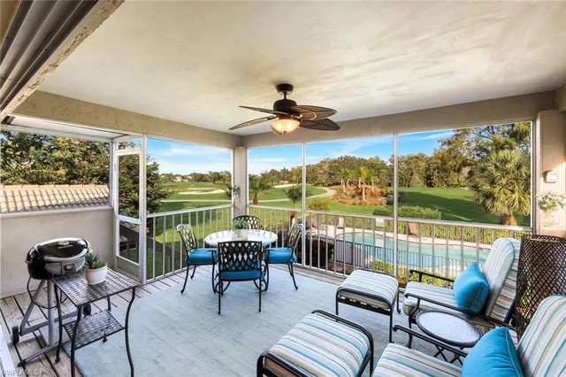 a balcony with furniture and a floor to ceiling window