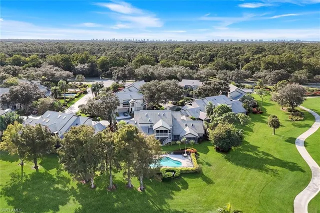 an aerial view of a houses with a yard