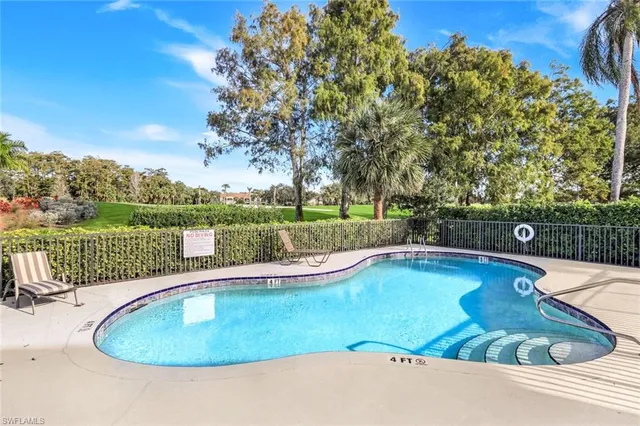 a view of a swimming pool with a patio and a yard
