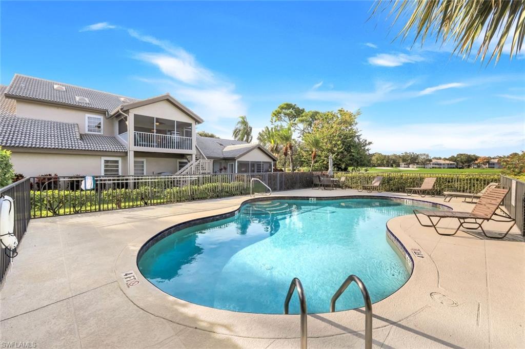 269 Perignon Place, Unit 162 Naples, FL 34119 - Photo 31 of 36 a view of a swimming pool with a lounge chairs