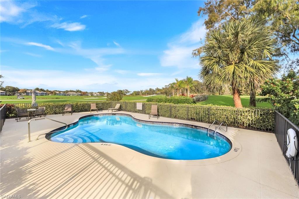 269 Perignon Place, Unit 162 Naples, FL 34119 - Photo 32 of 36 a view of a swimming pool with a lounge chair