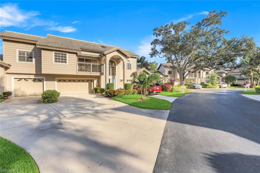 269 Perignon Place, Unit 162 Naples, FL 34119 - Photo 5 of 36 a front view of a house with a yard and potted plants