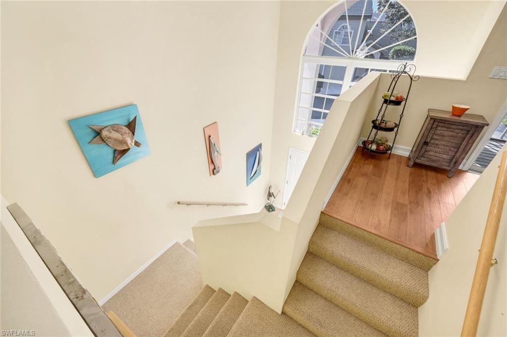 269 Perignon Place, Unit 162 Naples, FL 34119 - Photo 7 of 36 a view of stairs with furniture and wooden floor