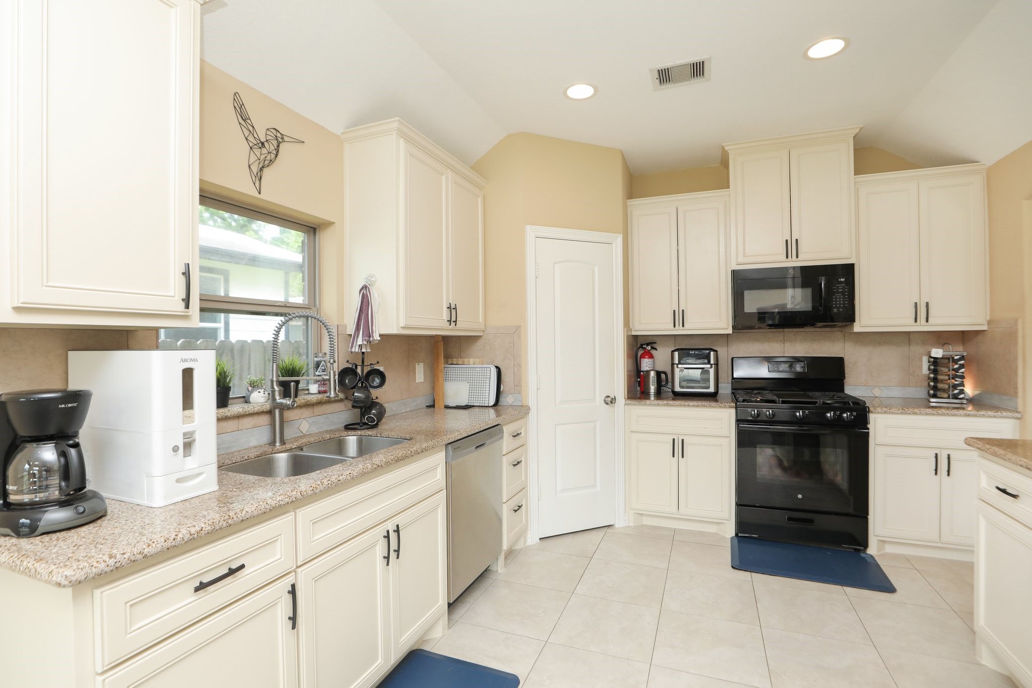 6615 Goldspier Street Houston, TX 77091 - Photo 12 of 37 Nice high ceilings, recessed lighting, granite tops and tons of cabinet storage PLUS a big pantry in the corner.