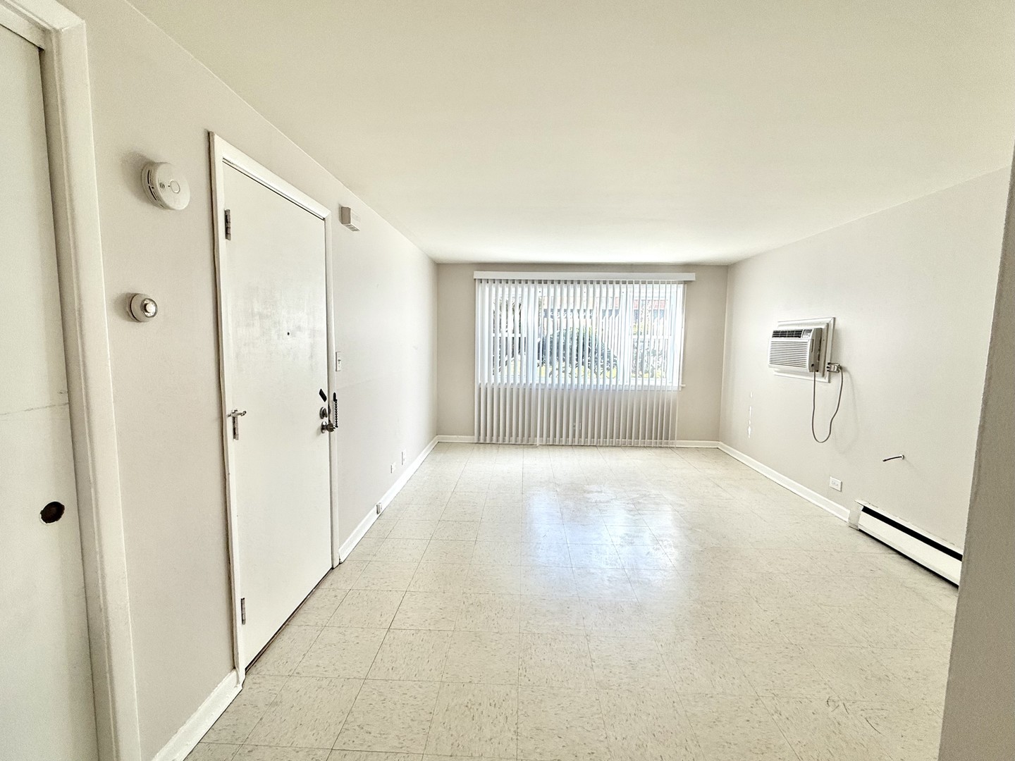8549 Niles Center Road, Unit GN Skokie, IL 60077 - Photo 2 of 8 a view of an empty room with a window