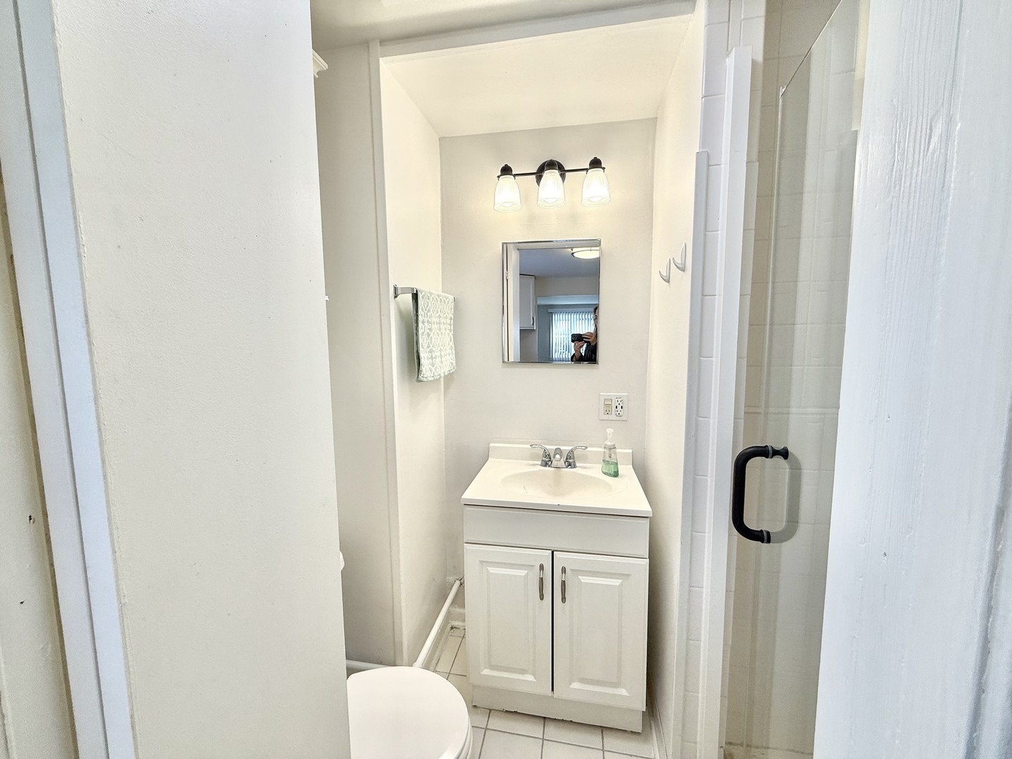 8549 Niles Center Road, Unit GN Skokie, IL 60077 - Photo 6 of 8 a bathroom with a toilet sink and mirror