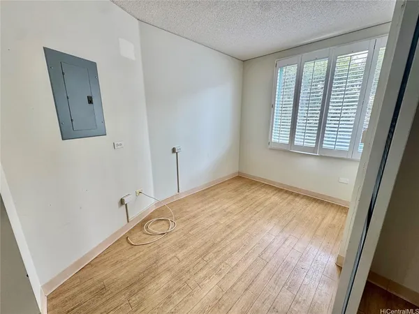 a view of a room with wooden floor and windows