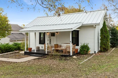 a view of patio with a table and chairs under an umbrella