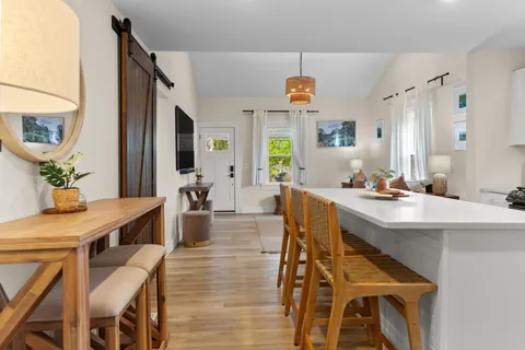 a view of a dining room with furniture and a chandelier
