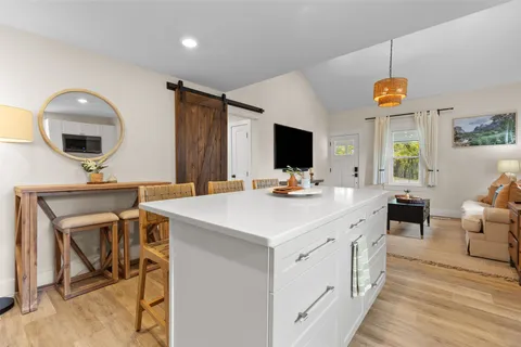 a kitchen with a sink cabinets and wooden floor