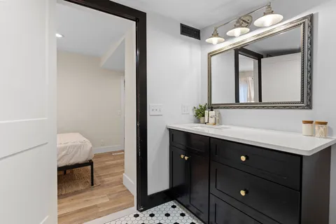 a bathroom with a sink vanity and a mirror