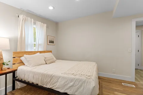 a bedroom with a bed and a window