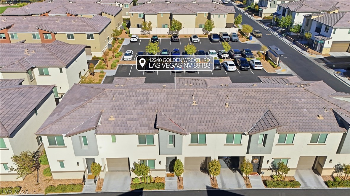 12240 Golden Wreath Road, Unit 2 Las Vegas, NV 89183 - Photo 22 of 29 Neat stucco townhomes sit nestled beneath durable tile roofs in a quiet neighborhood community.