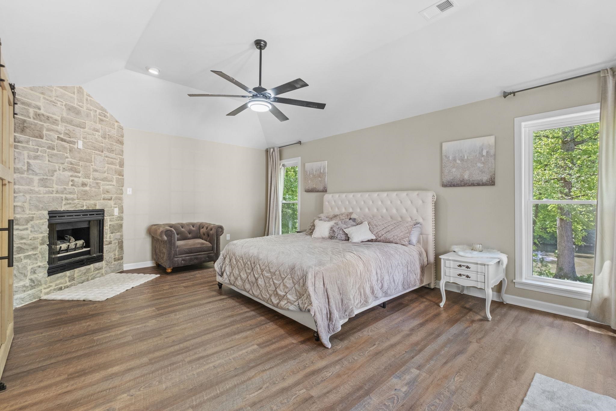 650 Firetower Road Somerville, TN 38068 - Photo 17 of 39 Bedroom with a fireplace, dark wood-style flooring, vaulted ceiling, and ceiling fan