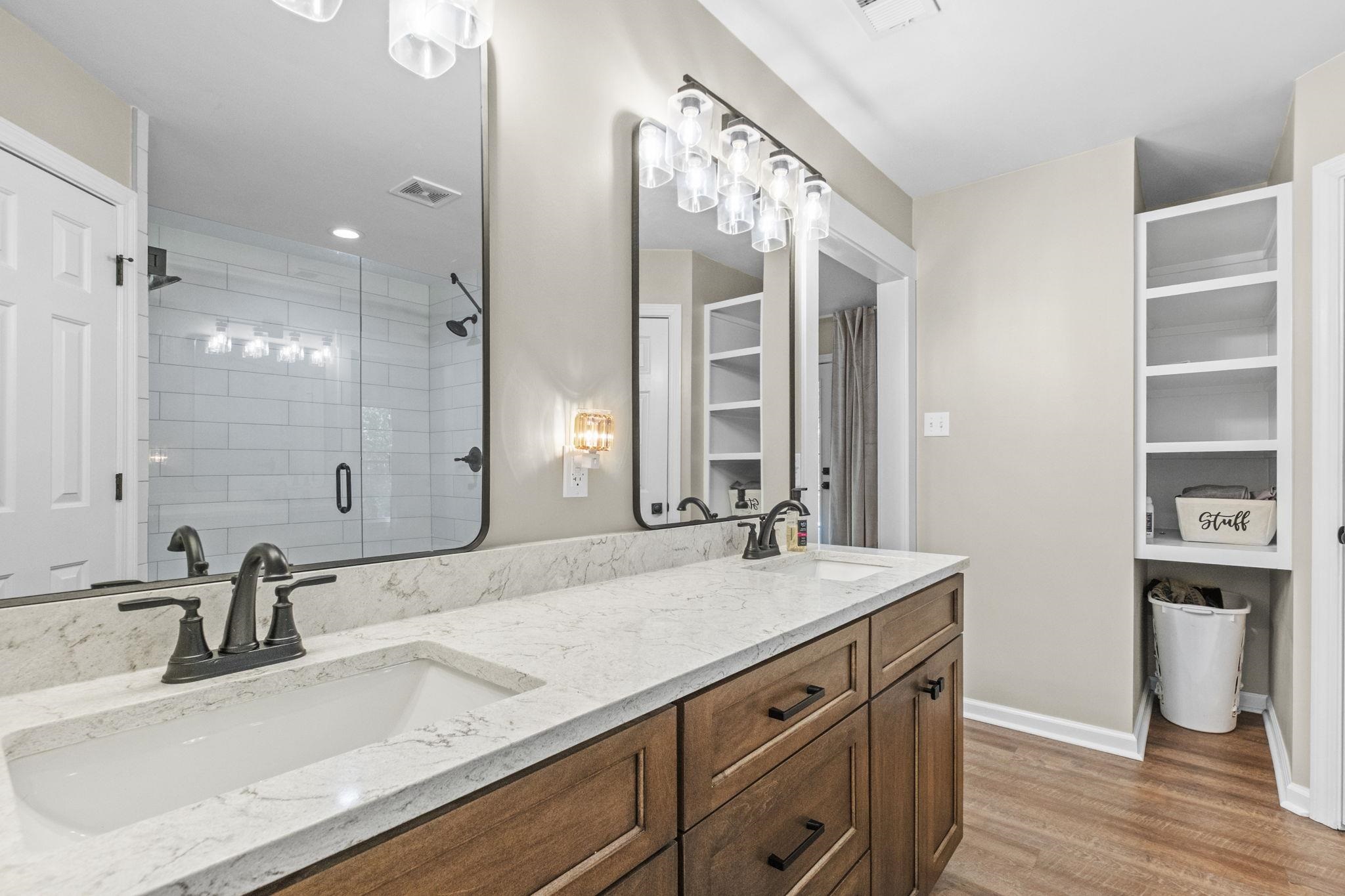 650 Firetower Road Somerville, TN 38068 - Photo 21 of 39 Full bathroom with double vanity, a shower stall, light wood-style floors, and a walk in closet