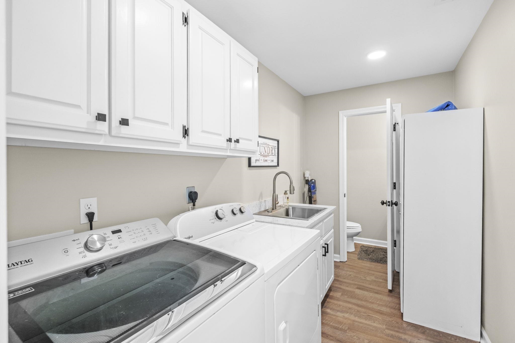 650 Firetower Road Somerville, TN 38068 - Photo 23 of 39 Laundry room featuring light wood finished floors, separate washer and dryer, cabinet space, and recessed lighting