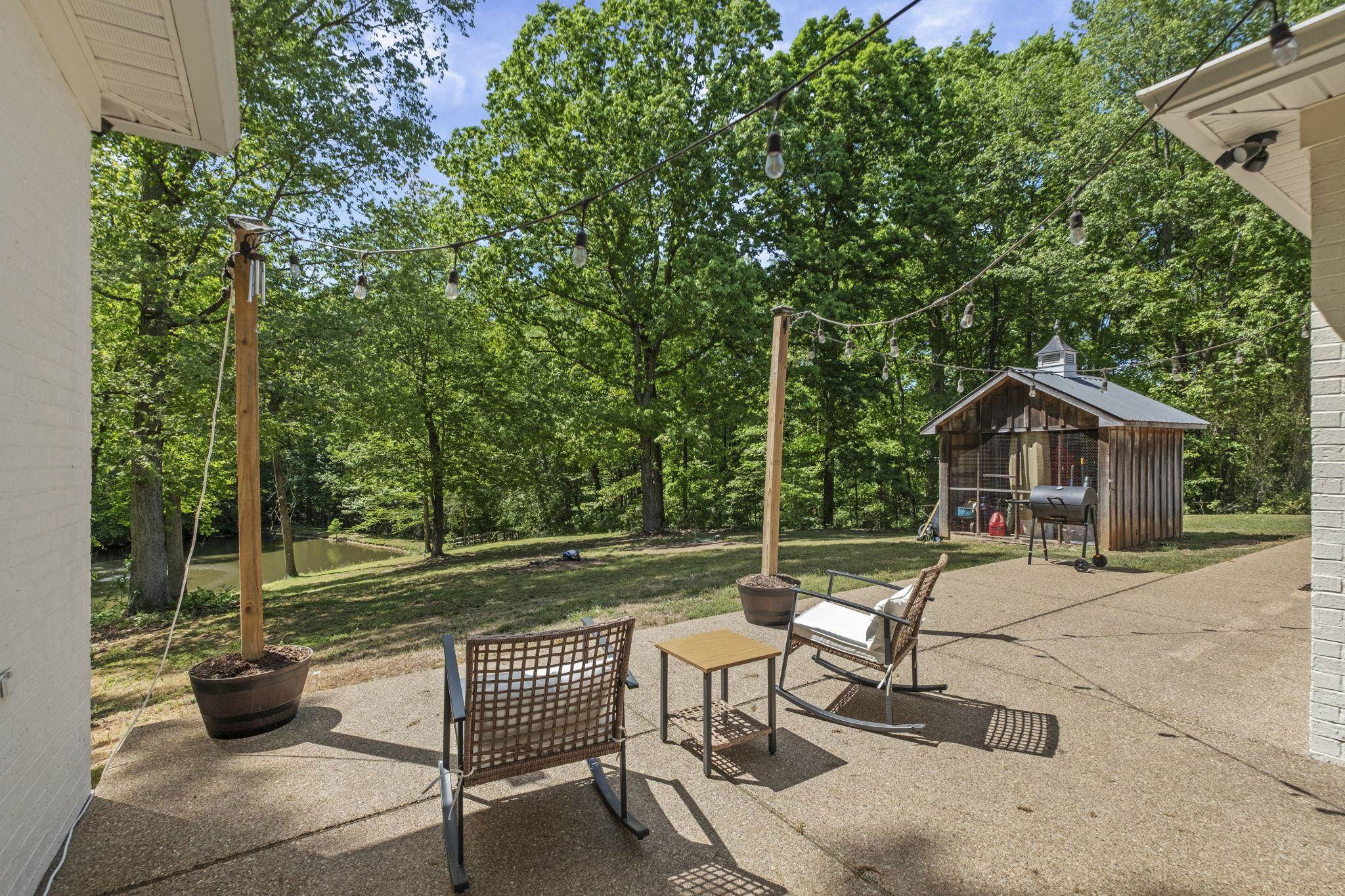 650 Firetower Road Somerville, TN 38068 - Photo 24 of 39 View of patio / terrace featuring area for grilling, view of scattered trees, and an outdoor structure