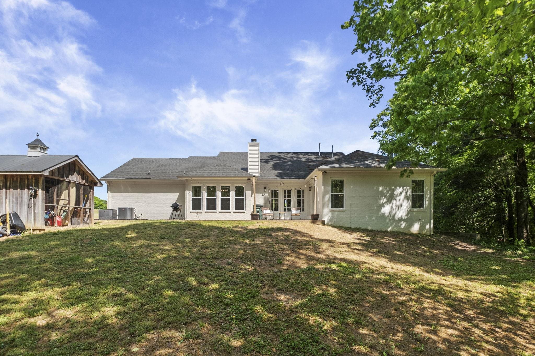 650 Firetower Road Somerville, TN 38068 - Photo 27 of 39 Back of property with a chimney, a patio, and a lawn